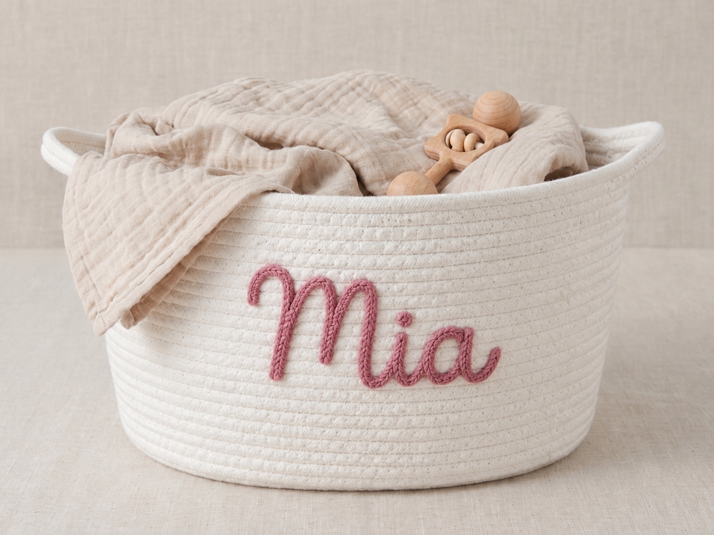 Illustrative cream rope basket with Mia in pink embroidery